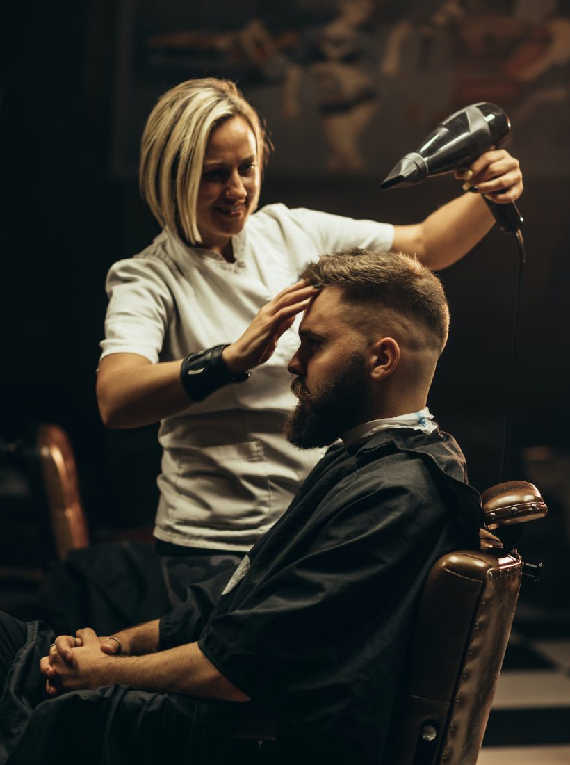 young-bearded-man-getting-haircut-by-hairdresser.jpg